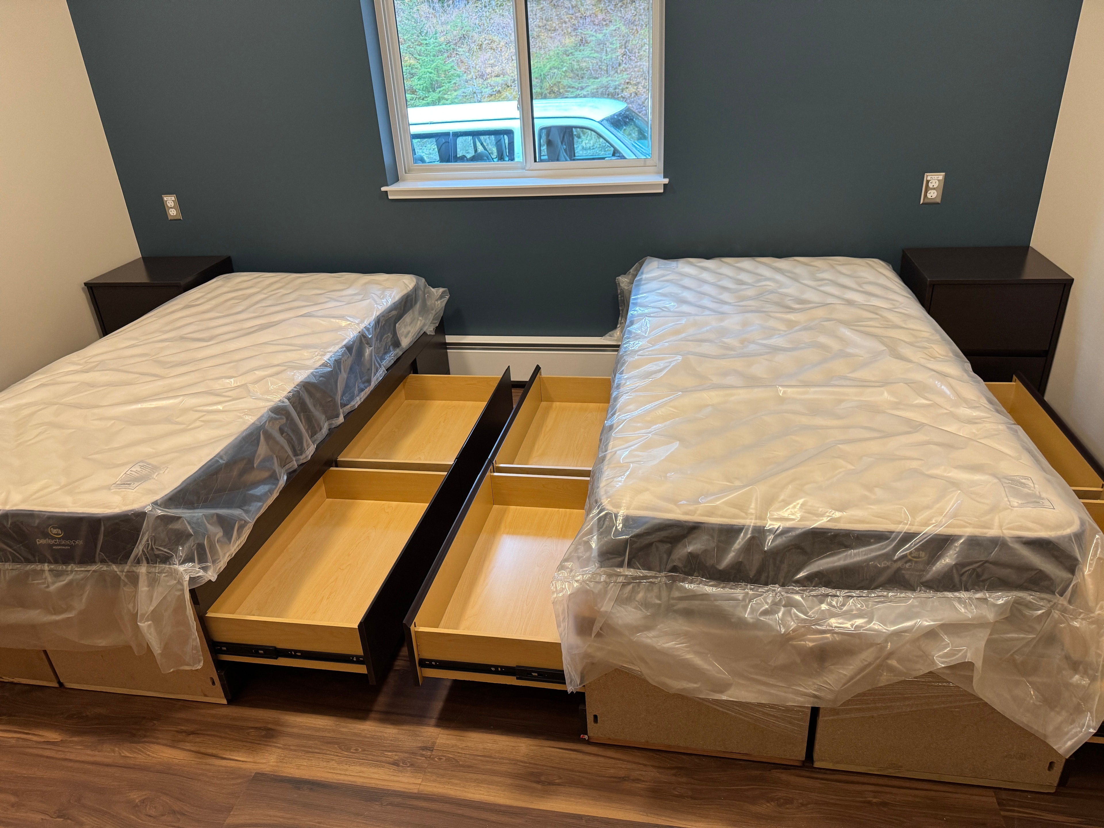 Newly assembled twin beds with mattresses installed by Spencer Restoration Services at the Glacier Bay National Park employee lodge in Alaska