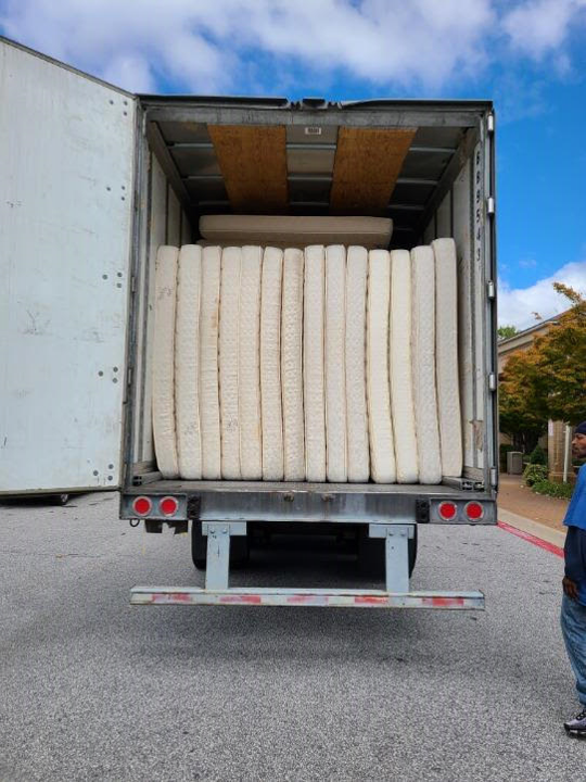 Truck loaded with old mattresses ready for recycling