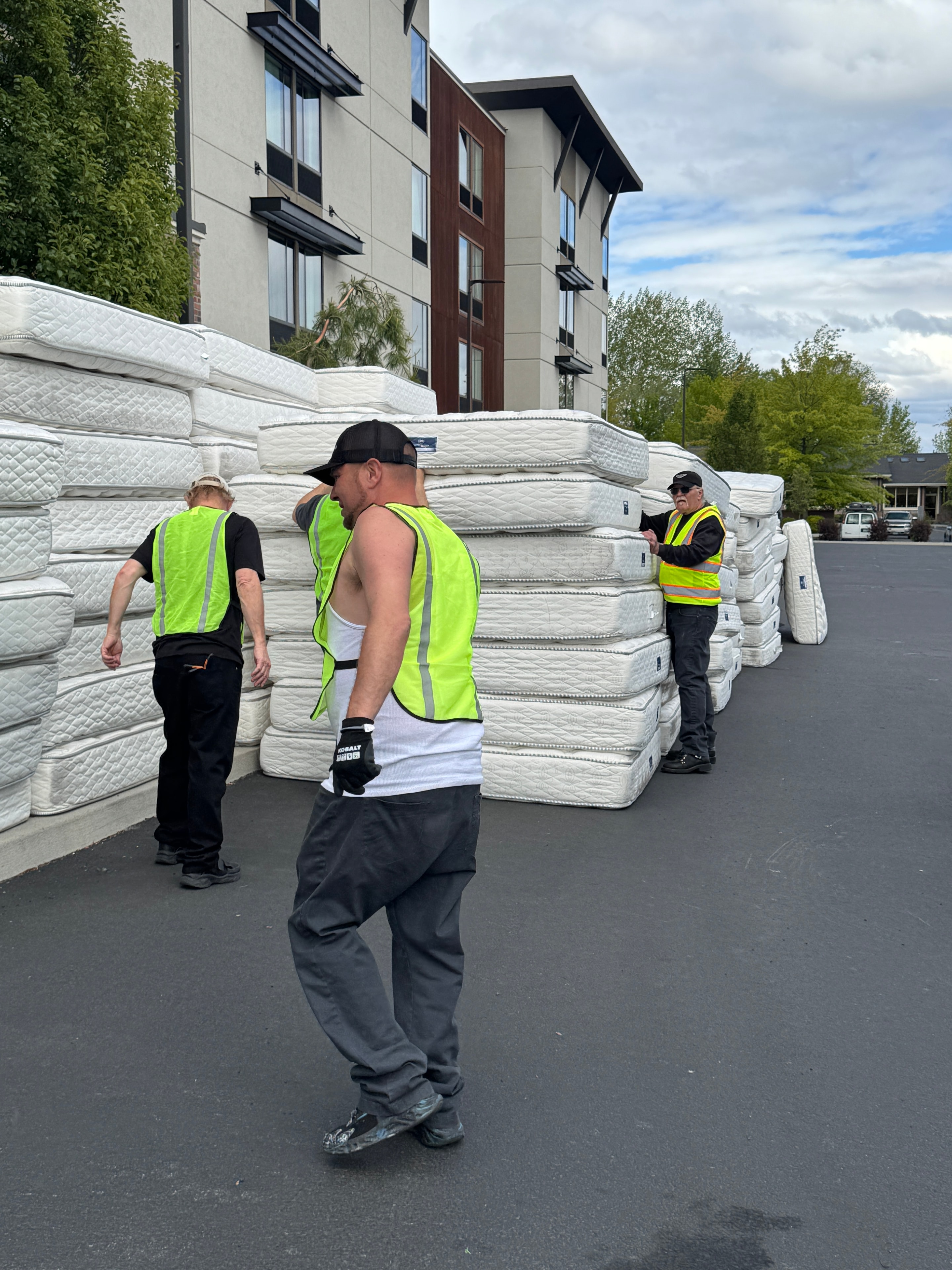 Spencer Restoration Services crew with a large stack of mattresses collected for reuse